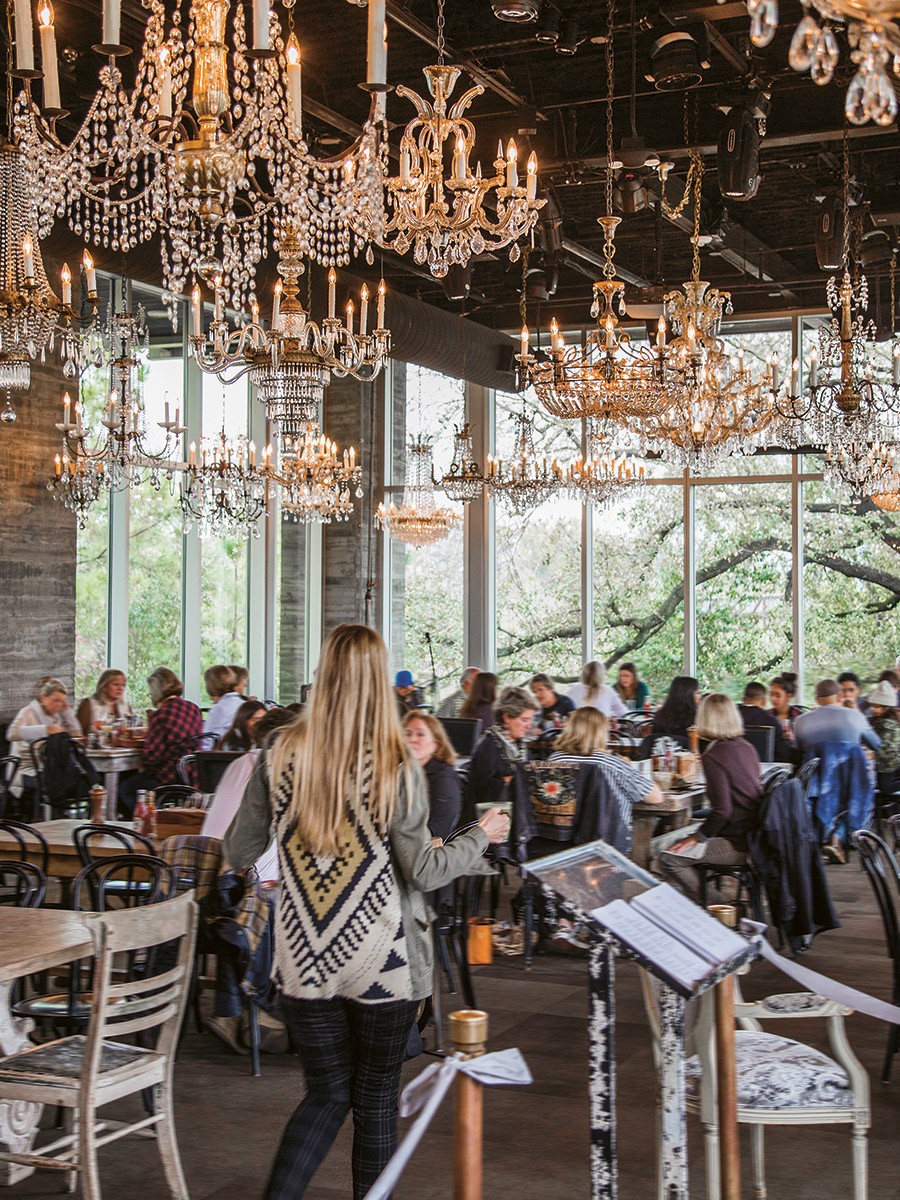 restaurant interior with people and chandeliers