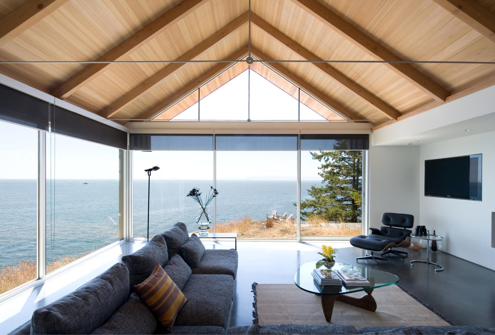living room with glass walls and ocean view