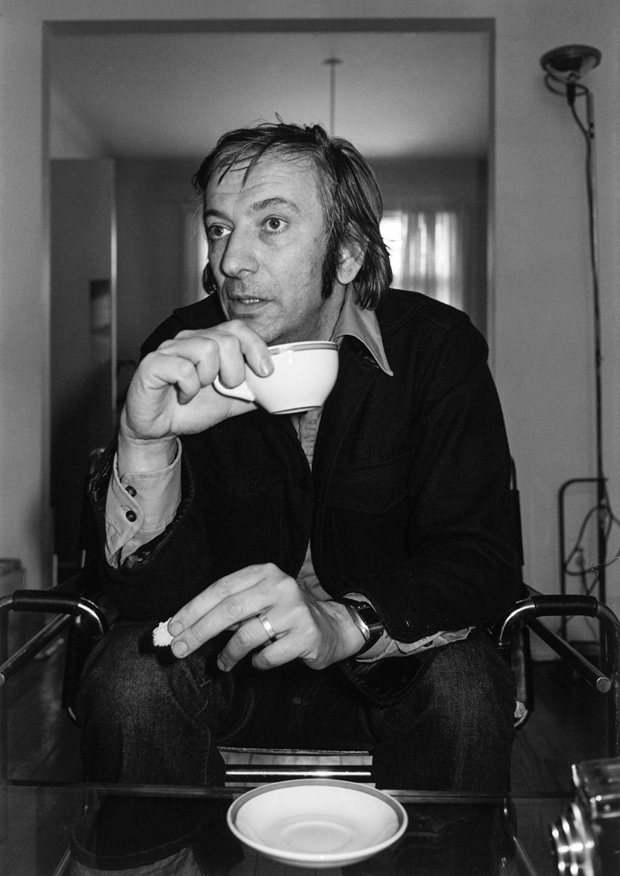 Black and white photo of Charles Gagnon holding a tea cup