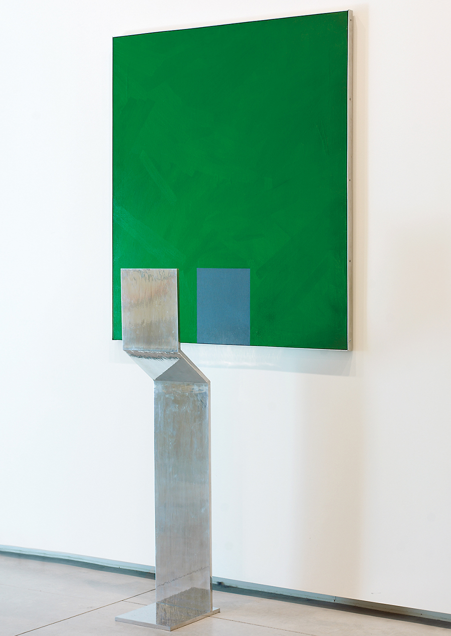 A green painting by Charles Gagnon held up by a metal stand