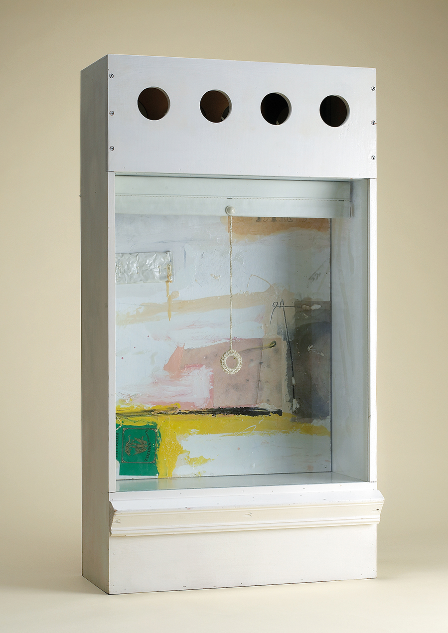 A cubic art piece by Charles Gagnon with a pendant-like object hanging in the middle