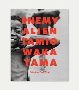 Book cover for Enemy Alien featuring bold red type on a black and white photo of a young boy smiling