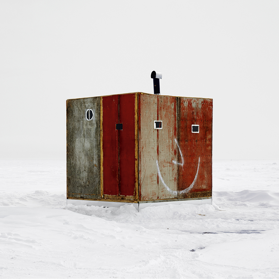Red cube fishing hut with a smiley face design