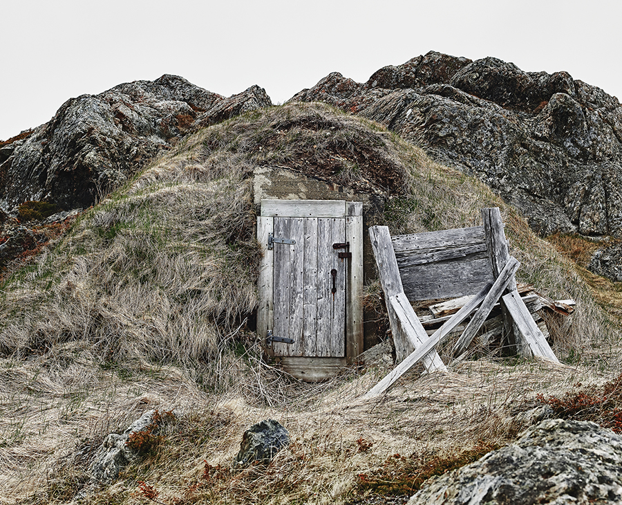 Root cellar embedded in a grassy knoll
